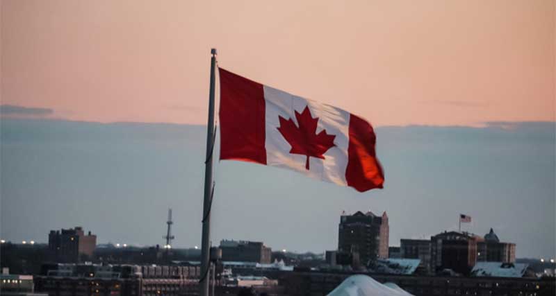 Canadian flag flying against skyline